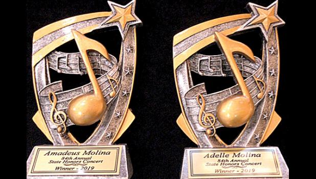 Special photo. The plaques earned by the Molina siblings for earning high marks at the state competition and being selected to play in the Honors Concert.