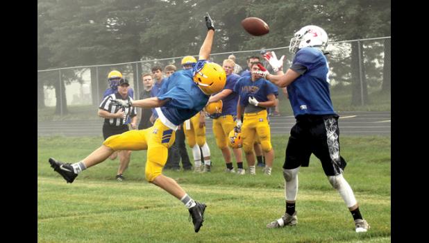 Staff Photo by Byron Higgin. Blake Reiss went high to deflect the ball away from his Tracy-Milroy-Balaton opponent in the scrimmage Saturday at Tracy.