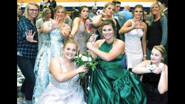 Special Photo. The softball team and head coach enjoy a moment together at prom, including teammate Brooklyn Nelson, (front). Others are: (Front row, left to right) Emily Pohlen, Nelson and Madison Sorensen. Back: Volunteer Coach Katie Boettger, Madison Scholten, Katie Konold, Sydney Larson, Abby Hennen and Coach Heidi Boerboom.