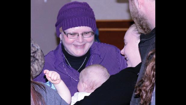 Staff Photo by Byron Higgin. Chris Hansen always has time to greet a new baby.