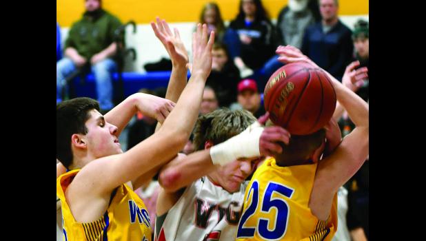 Photo for the Mascot by Brian Jeremiason. Jacob Citterman fought for a rebound with Westbrook-Walnut Grove's Ethan Mischke smashed between him and Riley Buysse.