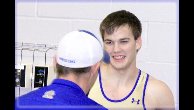 Staff Photo by Byron Higgin Champion Cole VanOverbeke flashed a smile to assistant Coach Kris Fier.