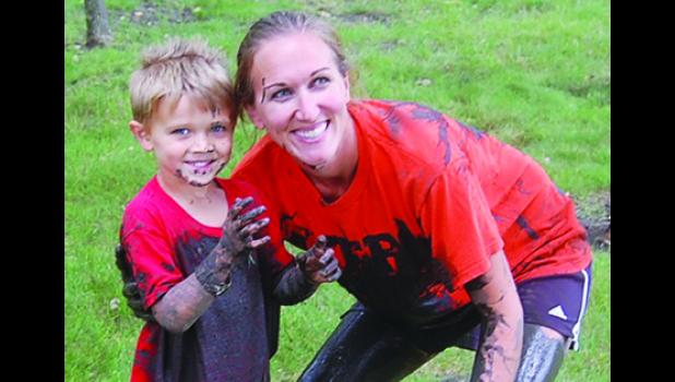 Staff Photo by Scott Thoma. Rykar Crowley, 3, and his mother Lori of Ghent celebrate the conclusion of the Mud Run with big smiles.