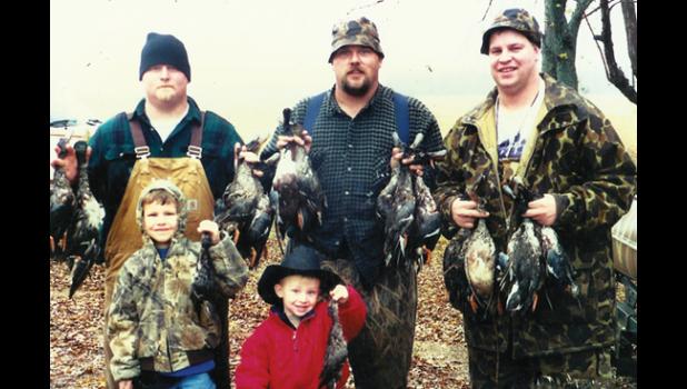 Contributed photo eff Arendt, Shawn Doyle and Ken DeBaere (DeBaere's sons, Tom and Alex, are in front) following a duck hunting trip on Oct. 29, 2000, one week before a tragic accident took Doyle's life.