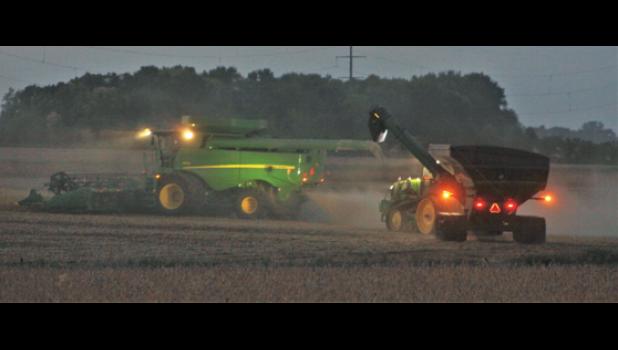 Mascot photo by Scott Thoma Farmers, such as these harvesting beans northeast of Minneota, often harvest well into the night.