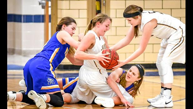 Photo by Brian Jeremiason. They fought for the ball on the floor. Morgan Kockleman and Natalee Rolbiecki went for it against Mary Bothun and Hannah Stelter.