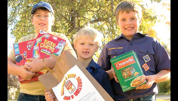 Staff Photo by Scott Thoma. Three Minneota Cub Scouts from Pack 30 collected non-perishable food items Saturday from community members for the annual Scouts 4 Food drive to combat hunger in the United States. Pictured from left to right are Jents Knutson, Max Laleman and Connor Boerboom.