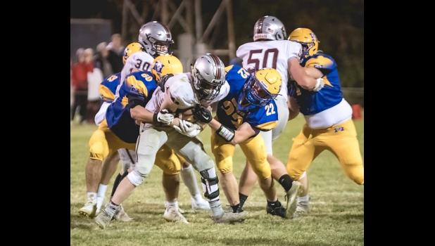 Mascot photo by Brian Jeremiason Alex DePestel (60) and Anthony Rybinski (22) of Minneota bring down Yellow Medicine East’s Owen Cherveny on Tuesday night in Minneota.