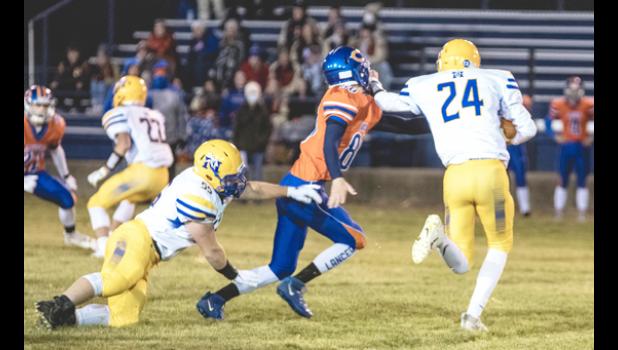 Mascot photo by Brian Jeremiason Minneota's Beau Banish, Trey Gronke and Jackson Esping help lead a goal line stand against Canby on Thursday night.