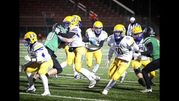 Mascot photo by Reba Lipinski Minneota’s Zack Fier runs through a large hole created by his teammates against Breckenridge on Friday night in the Class A quarterfinals in Alexandria.