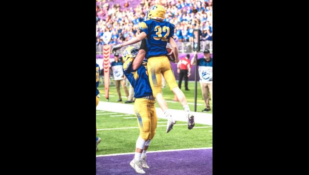 Mascot photo by Brian Jeremiason Adam DeVlaeminck (32) is hoisted in the air by Ben Schmidt after scoring a seven-yard touchdown in the fourth quarter.