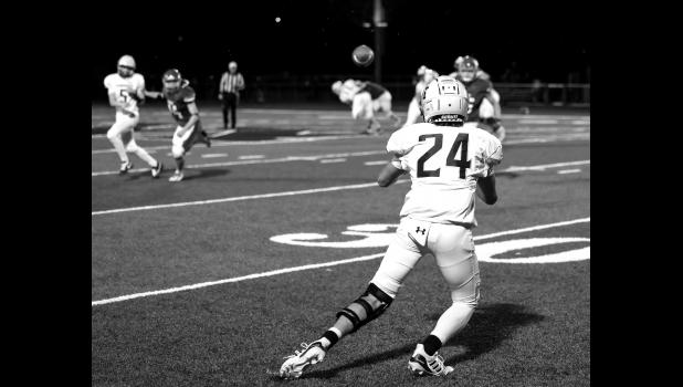 Mascot photo by Emma Lipinski Minneota quarterback Tristen Sussner (5) completes a pass to Kaden Christensen against MACCRAY lst Friday night.