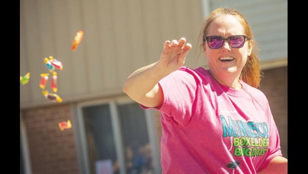 Mascot photo by Brian Jeremiason Tammy Esping throws candy to the kids during the Grande Parade on Sunday.