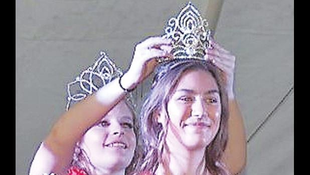 Contributed photo Faith Myhre was crowned Boxelder Bug Days Queen by last year's queen, Kaitlyn Ludwikowski.