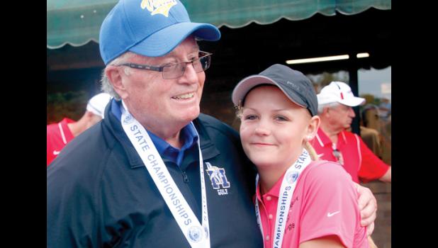 File Photo by Byron Higgin. Coach Greg Gile celebrated at the 2015 State Class A golf tournament with one of the golfers he counts as the most dedicated, Kyra Gores.