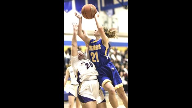 Mascot photo by Brian Jeremiason Kiersyn Hulzebos (21) of Minneota drives to the basket for two of her 12 points against Montevideo last Friday in Minneota.