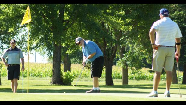 Mascot photo by Sue Jacobson Brian Obe, center, putts while Gabe Piper, left, and Harlan Ulrich look on during competition in the First Flight.