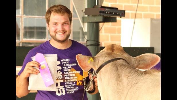Contributed photo Grady Moorse proudly displays his champion ribbon at the 4-H dairy show during the Yellow Medicine County Fair.