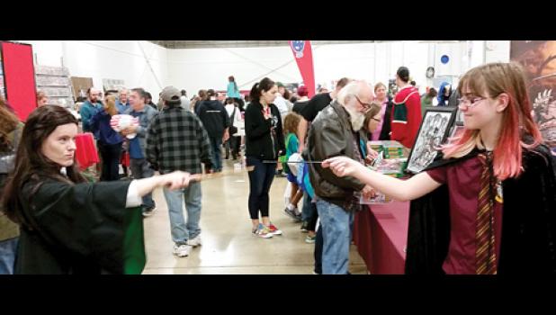 Staff Photo by Cherri Schmig. Kara Schmig posing with a Slytherin character (Harry Potter).