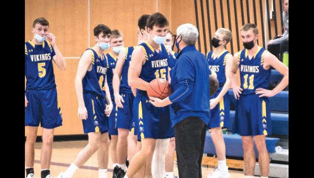 Photo for the Mascot by Brian Jeremiason. Minneota senior Jacob Hennen is given the game ball by head coach Dave Busselman after scoring his 1,000th career point on Saturday night.