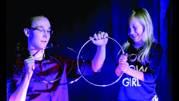 Photo by Byron Higgin Illusionist Jett Skrien showed his magic "inter-locking" rings to a young believer.