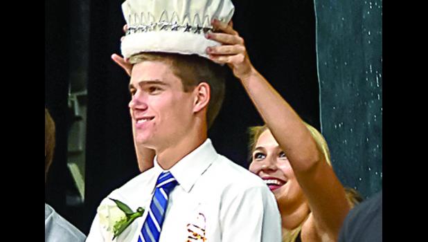 Photo for The Mascot by Brian Jeremiason. The crown as Homecoming King was placed on the head of Thomas Hennen as Morgan Hennen did the honors and was all smiles.