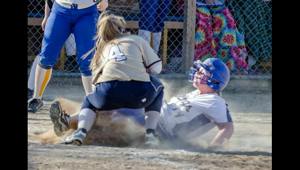 Photo for the Mascot by Brian Jeremiason. Larissa Kockelman slides home with a run for Minneota-Canby.
