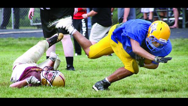 Staff Photo by Byron Higgin LaShad Smith went for a few extra yards after he was hit by a Springfield tackler in the scrimmage at Tracy on Saturday.