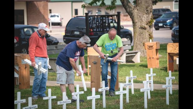 Mascot photo by Brian Jeremiason Taunton VFW prepared for Monday’s Memorial Day services by placing memorial crosses and flags in Veterans Park this week. They also placed flags on the gravesites of veterans in local cemeteries.