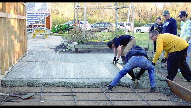 Staff Photo by Byron Higgin Leveling the concrete.