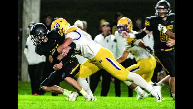 Photo for the Mascot by Brian Jeremiason. Logan Sussner sacked Dawson quarterback Brendan Stutz.