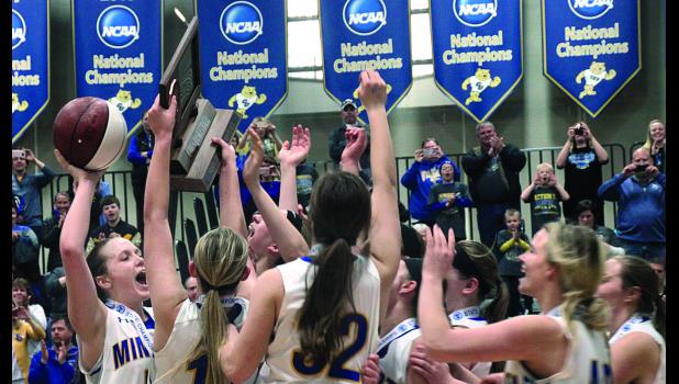 Captain Lydia Sussner held the ball and trophy awarded to Minneota for capturing third place. The others gathered to share in the fun after they beat Mt.Iron-Buhl for third place, 74-56.