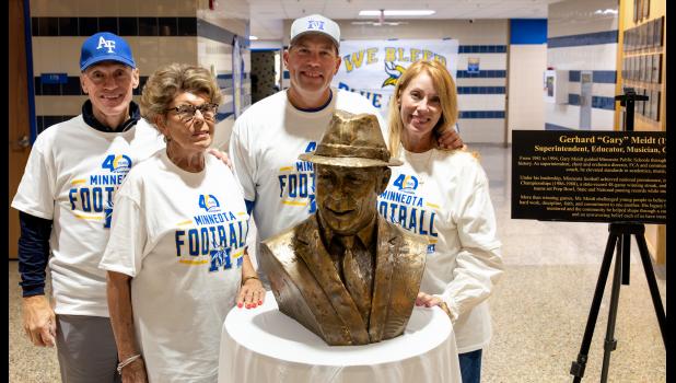 Gerhard and Nancy Meidt’s children posed with the bronze bust of their father on Friday. Left to right: Greg Meidt, Karen Meidt, Chris Meidt and Melody (Meidt) Leidall.
