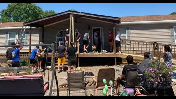 Contributed photo Members of the Minneota Area Mission Group repair the front porch of a home in Mississippi last summer.