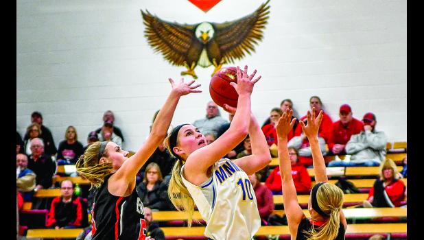 Photo for the Mascot by Brian Jeremiason Morgan Hennen drove between Grace Hegland (left) and Isabelle Schirm of Lac qui Parle Valley to score two of her game-high 24 points. the LqPV Eagle watched over the action (top).