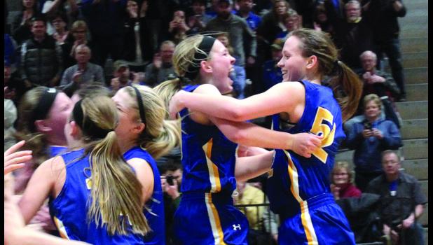 Staff Photo by Byron Higgin. Morgan Hennen and Lydia Sussner (right) celebrate the victory as their teammates rush to join them.