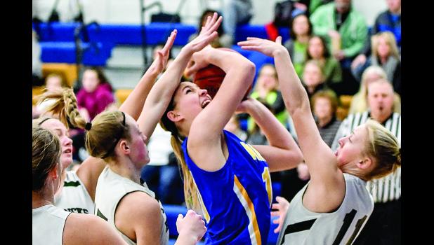 Photo by Brian Jeremiason. Morgan Hennen was surrounded by Hendricks players.