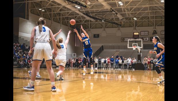 Photo for the Mascot by Brian Jeremiason Natalee Rolbiecki knocks down a three pointer.