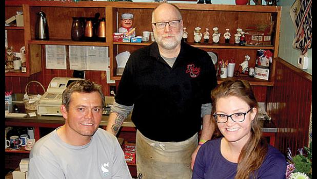 Staff photo by Scott Thoma. Brad and Courtney Norcutt will be taking over as owners of Rusty's Corner Café on Jan. 1. Rusty Rhymer, standing, has owned the business the last 30 years. The new café will be called Duke's Corner Café.