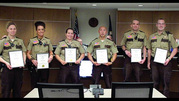 Staff Photo by Byron Higgin Getting their awards from Sheriff Eric Wallen were: (left to right) Hillary Buysse, Valerie Peichel, Alissa Determan, John Xiong, Brock Schultz and Leighton Otto.