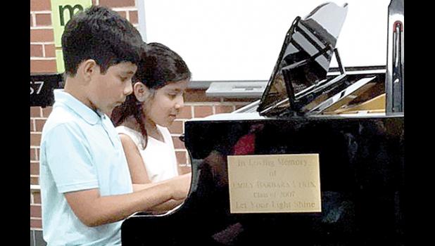 Special photo. The Molina siblings rehearsing for the Honors Concert.