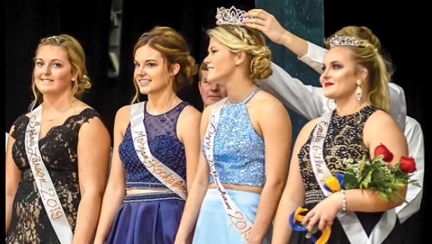 Photo for The Mascot by Brian Jeremiason. Placing the Homecoming Crown on Lizzy Gillingham’s head was Tate Walerius. The other candidates are: (left to right) Sydney Larson, Morgan Kockelman and right, Princess Emily Pohlen.
