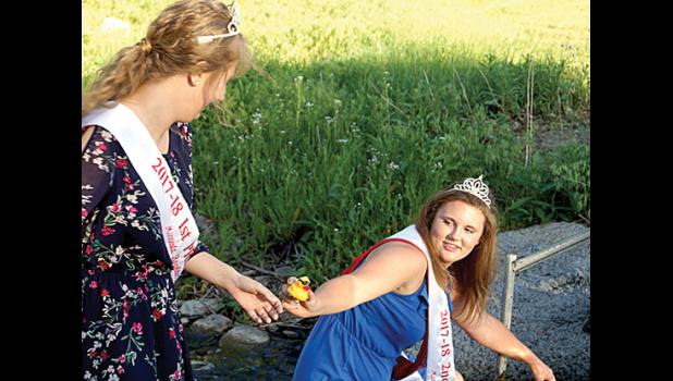 Photo for The Mascot by Brian Jeremiason. Brooklyn Nelson pulled a duck from the pond and gave it to Grace Jeremiason.