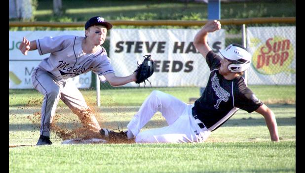 Staff Photo by Byron Higgin Sam Buysse stole second against Madison. Gavin Fernholz was late with the tag.
