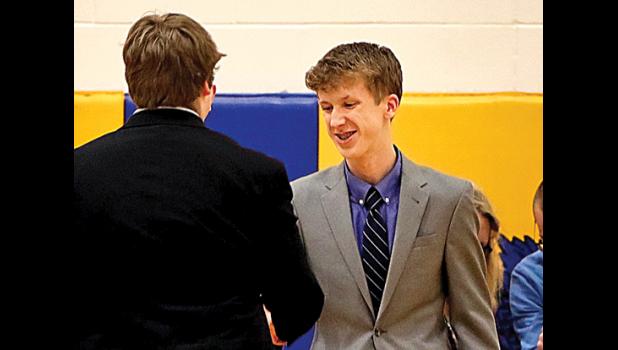 Photo by Reba Lipinski. Sean Dilley accepts his first place award.