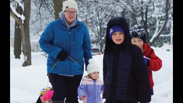 Photo for the Mascot by Sue Jacobson. This group ventured out on Friday. Pierce Ashman (front) pulls Ryder Myhre while Jacob Swoboda follows behind. Violet Swoboda (purple) and Laura Swoboda are pulling Gemma Myhre and Lily Swoboda.