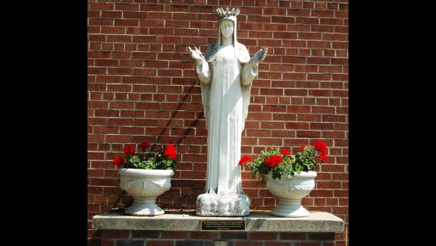 This historic 62-inch statue sits outside St. Edward’s Catholic School beside the church. It has deteriorated over time due to the elements and now parishioners are attempting to raise money to have it repaired. Mascot photo by Scott Thoma