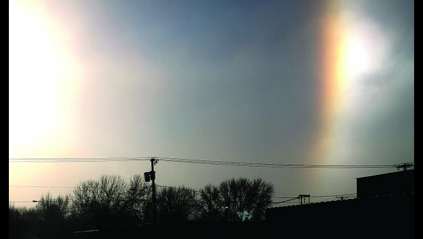 Staff Photo by Byron Higgin This Sundog in the image of a Rainbow appeared over Brad's Market in Minneota on Tuesday morning. The sun shone brightly (left).