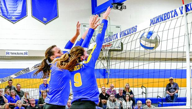 Photo for the Mascot by Brian Jeremiason Lydia Sussner and Morgan Kockelman block the ball and sent it back to the other side of the net.