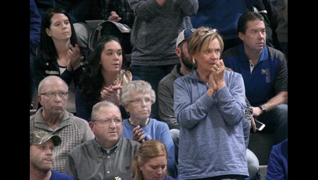Staff Photo by Byron Higgin. Among them were Marty and Andrea Rost, looking down. Jerome Jerzak behind her with Alvin and Marilyn Smith and Sherry Rost standing to clap. Dawn Stienessen, Taya Kockelman and Darin Yost were behind them.